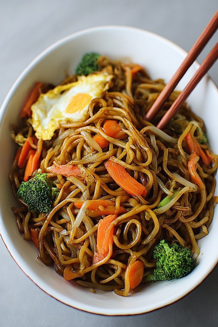 Chinese-style fried noodles with egg and vegetables image 2